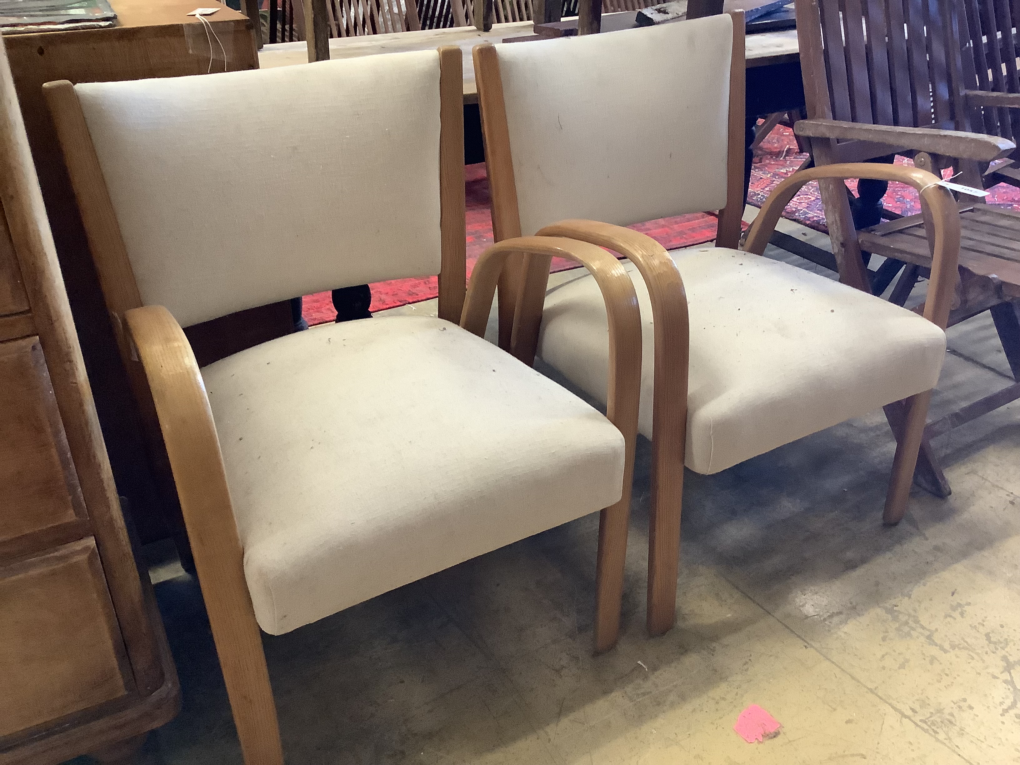A pair of mid century elbow chairs